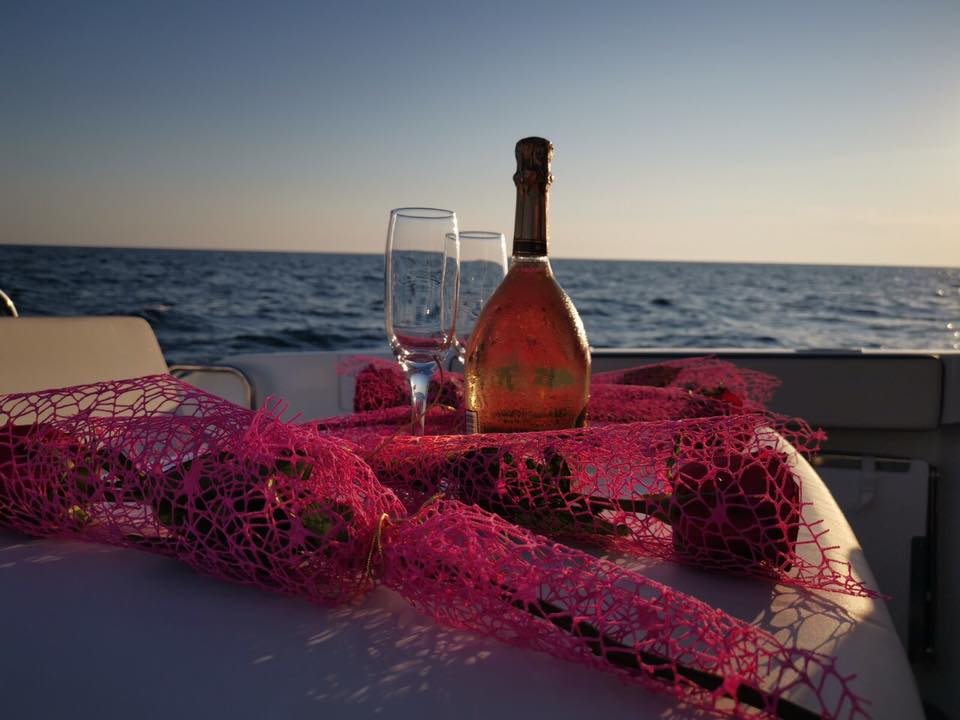 Premium wine bottle elegantly displayed on boat table with sea view and luxury dining experience
