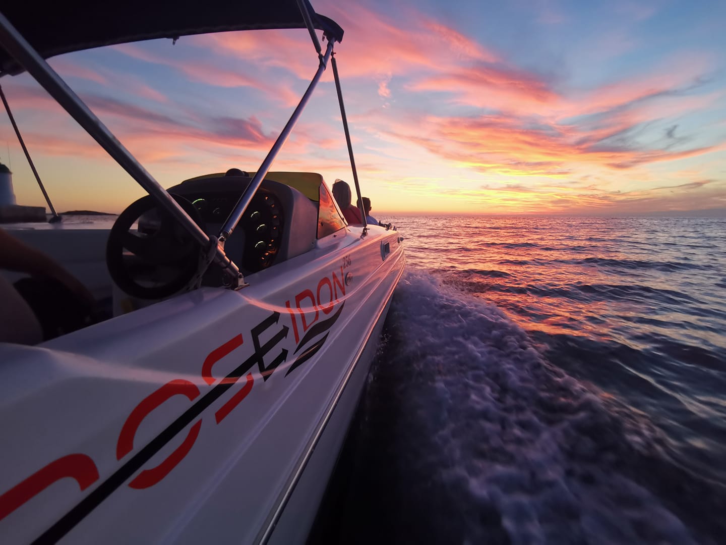 Romantic sunset boat ride on the Adriatic Sea with golden sky reflecting on calm waters